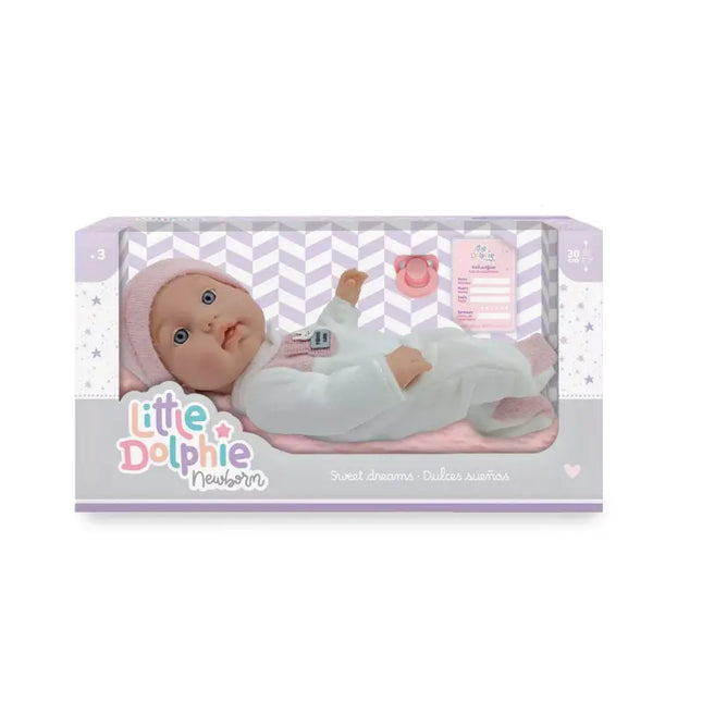 Muñeca recién nacida de 30 cm con cuerpo de vinilo. Incluye cobija, almohada y chupete.