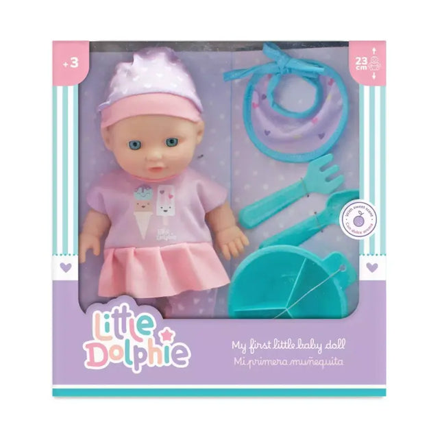 Muñeca de 23 cm  y extremidades de vinilo. Incluye cubiertos, platito y babero.
