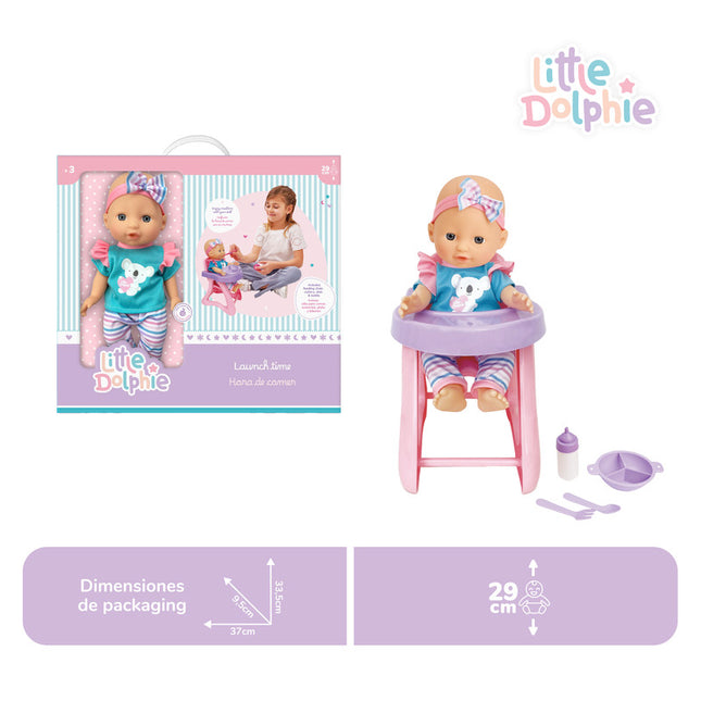 Muñeca de 29 cm con extremidades de vinilo y suave aroma. Incluye silla para comer, cubiertos, platito y mamadera.